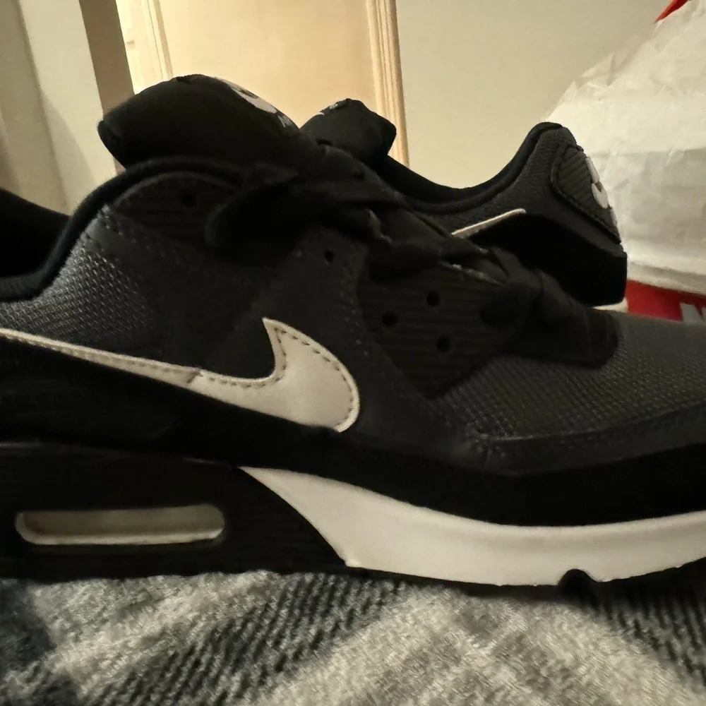 Nike Air Max 90 sneaker in a black iron grey and dark smoke grey colorway Size10